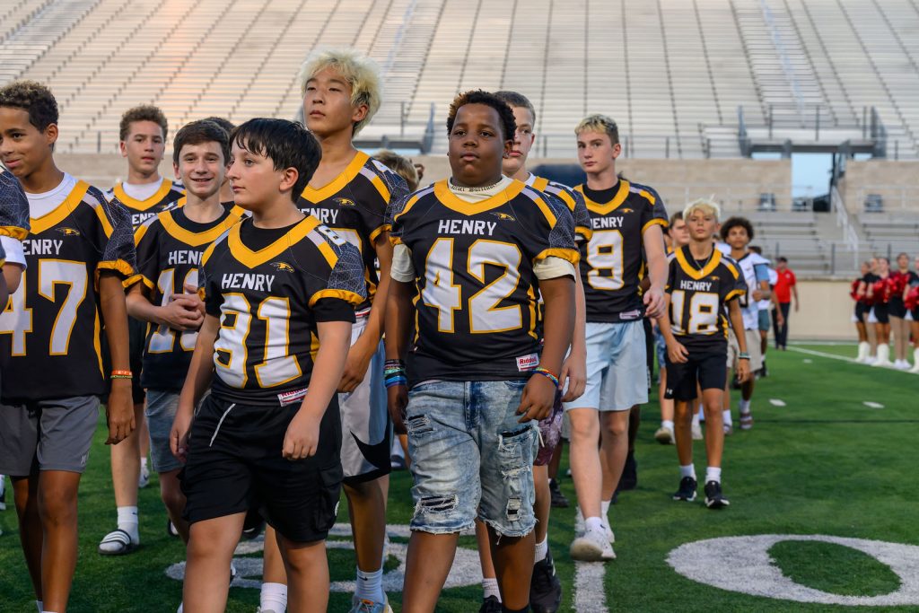 Henry Hawks 8th grade football players on the field at Rally at the Ridge, Gupton Stadium