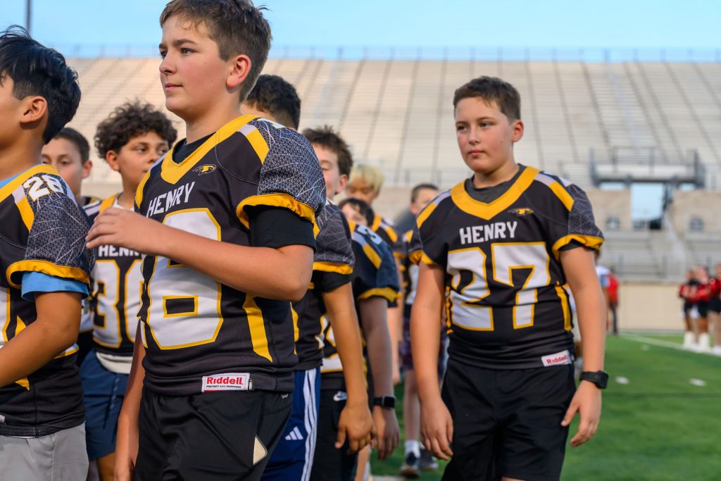 Henry Hawks 8th grade football players on the field at Rally at the Ridge, Gupton Stadium