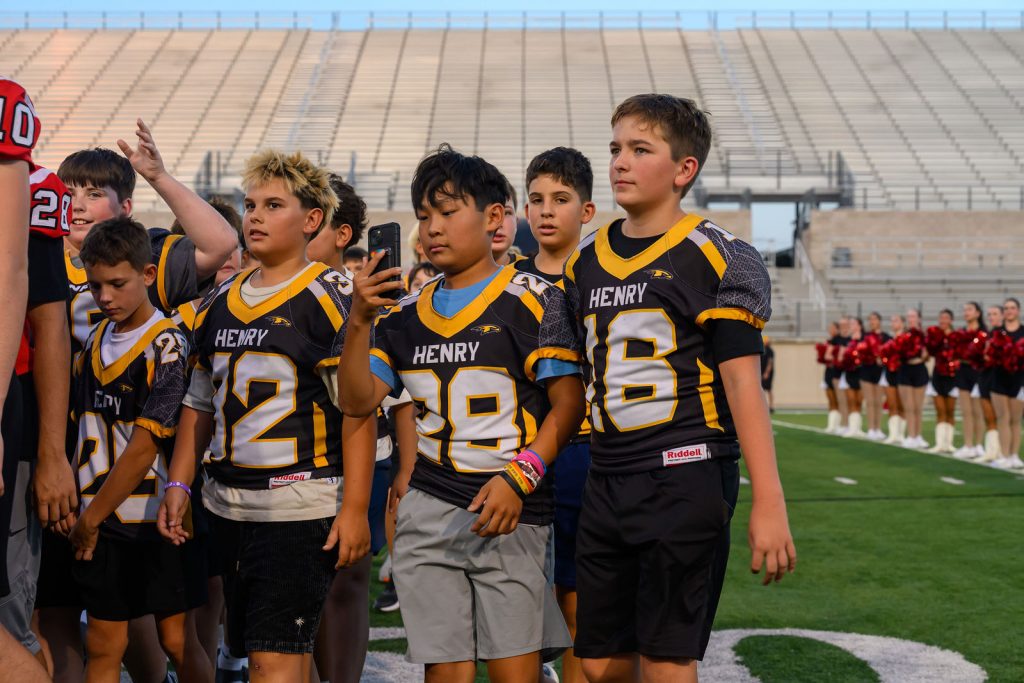 Henry Hawks 8th grade football players on the field at Rally at the Ridge, Gupton Stadium
