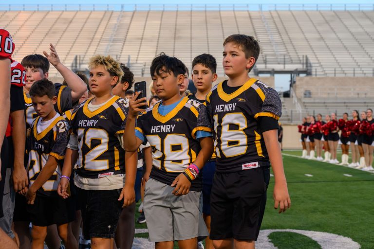 Henry Hawks 8th grade football players on the field at Rally at the Ridge, Gupton Stadium
